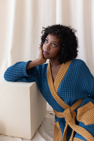 Indigo Blue Caramel handwoven waffle two-tone kimono bathrobe sitting lean. Handwoven Denizli, OEKO-TEX. Vivamaison.