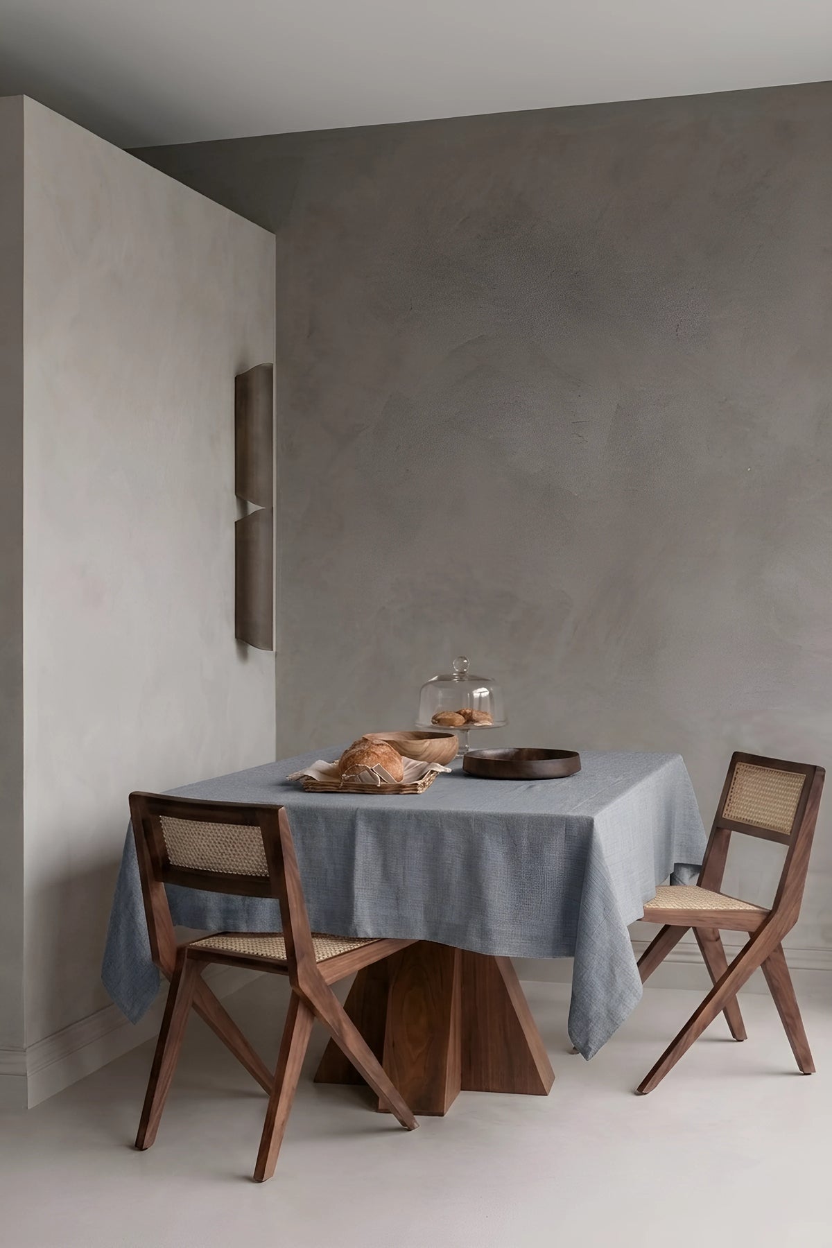 Gray plain linen cotton blend tablecloth on a dining table in a modern dining room with cane chairs. 9 sizes, handmade in Denizli, OEKO-TEX. VivaMaison.