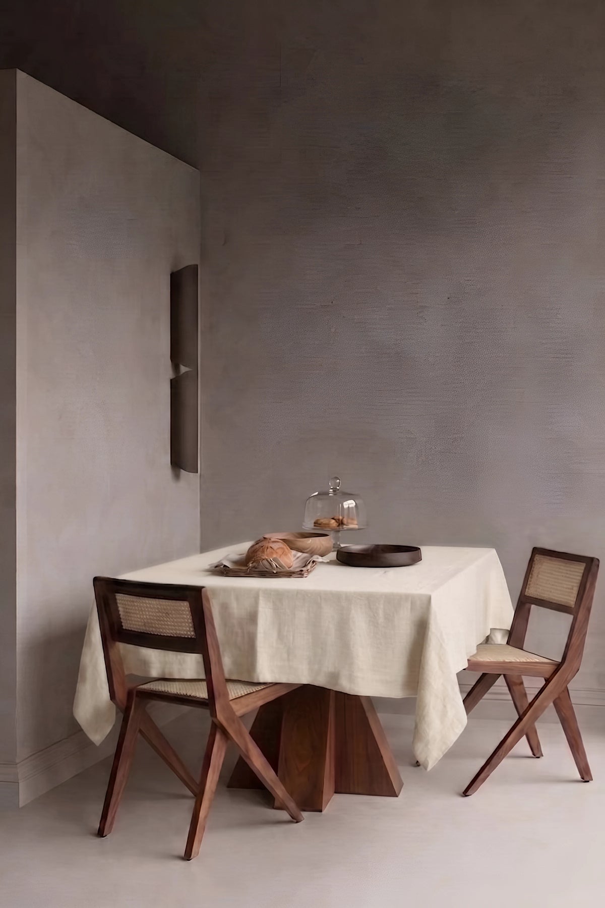 Natural plain linen cotton blend tablecloth on a dining table in a modern dining room with cane chairs. 9 sizes, handmade in Denizli, OEKO-TEX. VivaMaison.