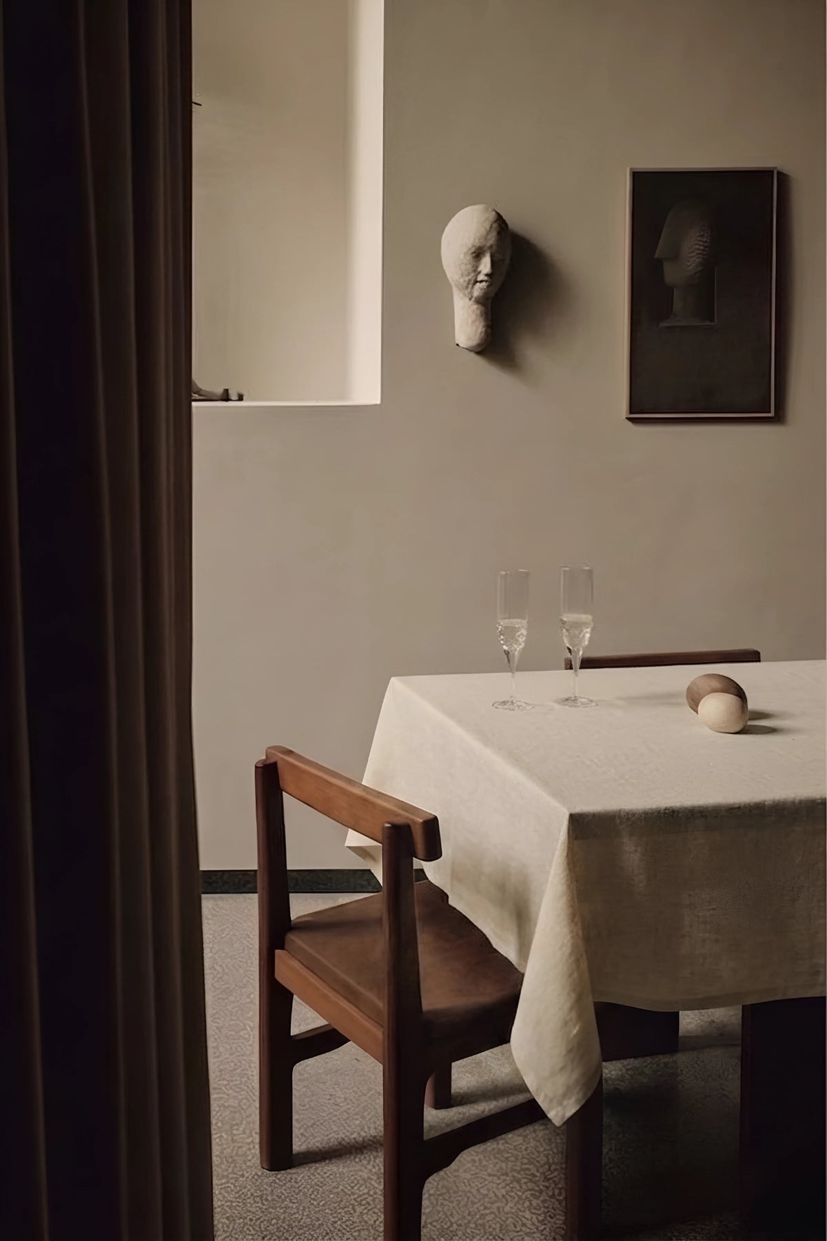 Natural plain linen cotton blend tablecloth on a dining table with champagne flutes, seen through a doorway. 9 sizes, handmade in Denizli, OEKO-TEX. VivaMaison.