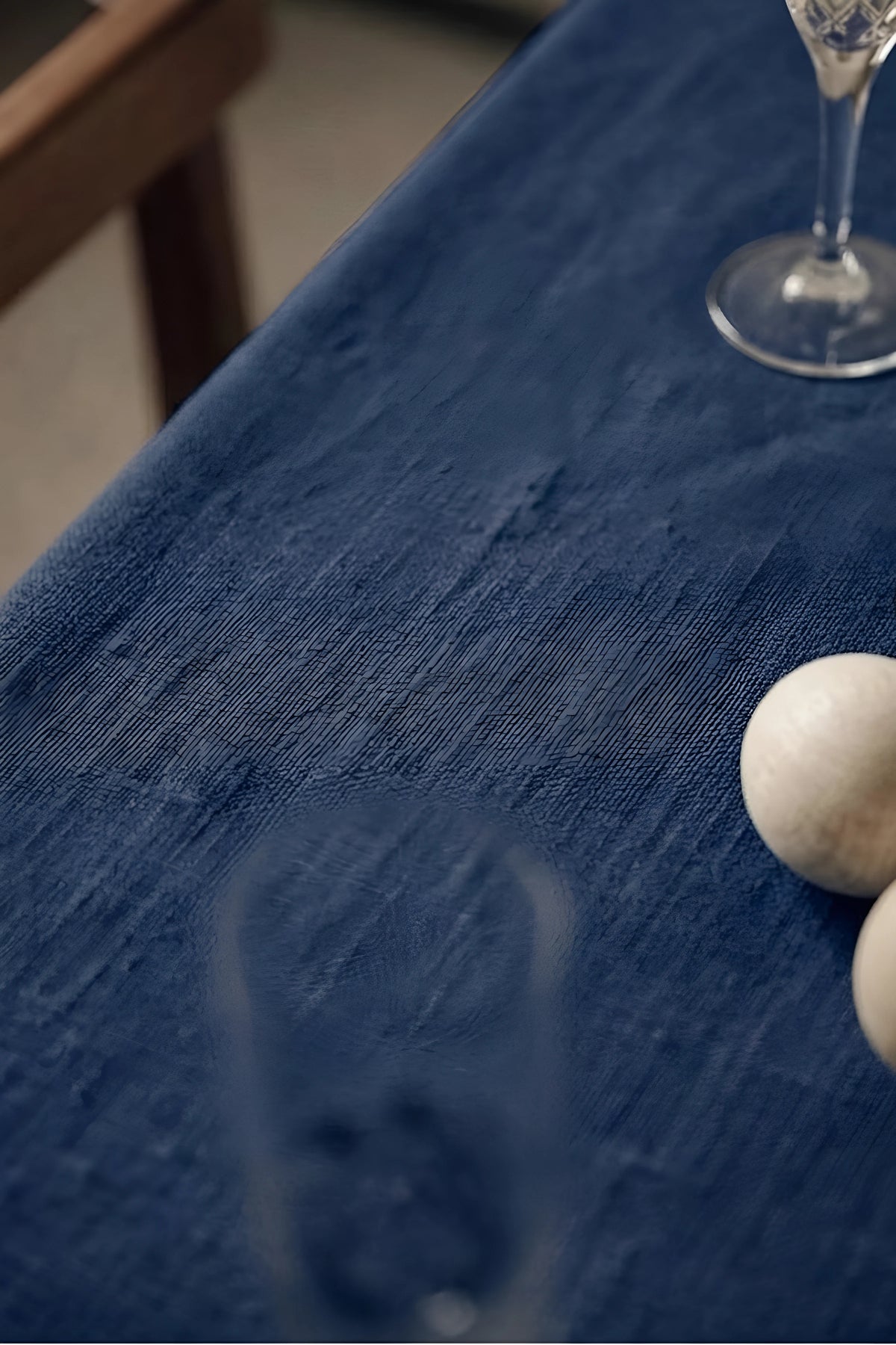 Navy plain linen cotton blend tablecloth fabric texture close-up with a wine glass. 9 sizes, handmade in Denizli, OEKO-TEX. VivaMaison.