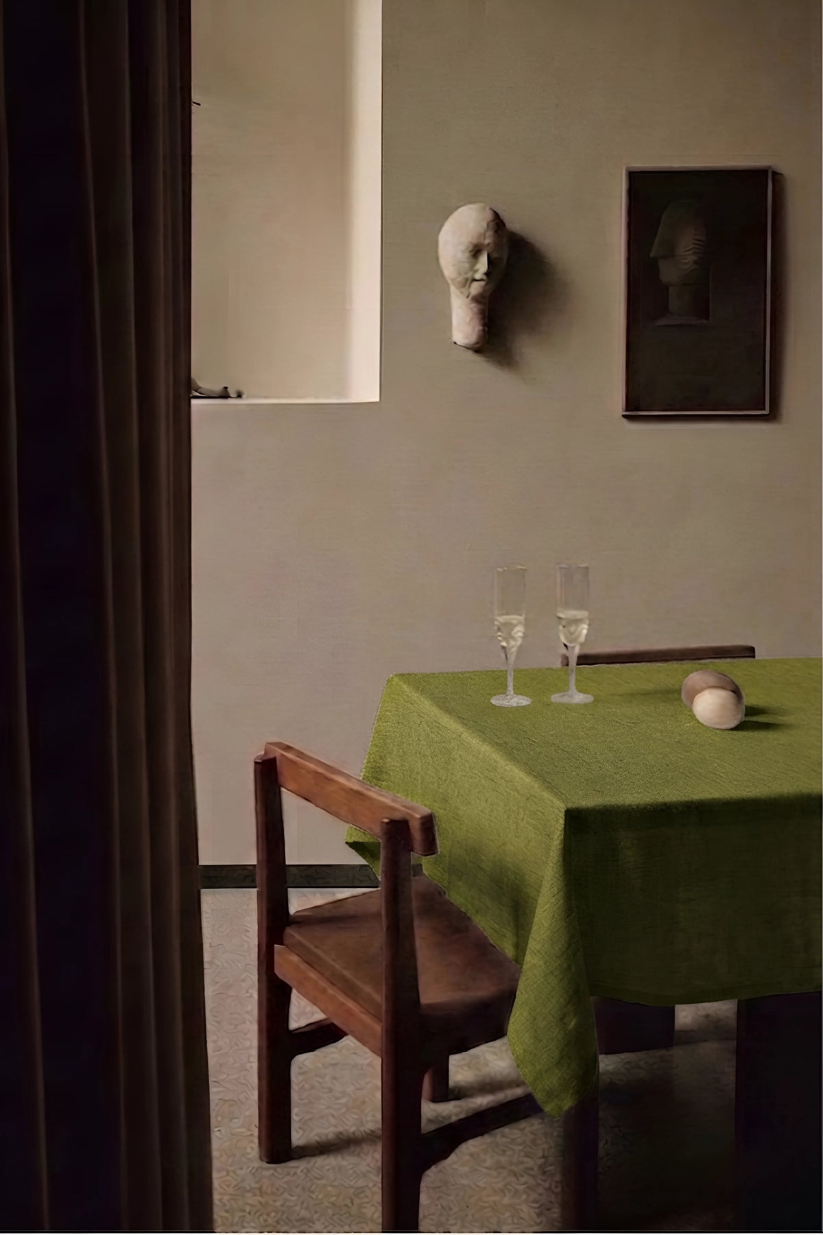 Olive Green plain linen cotton blend tablecloth on a dining table with champagne flutes, seen through a doorway. 9 sizes, handmade in Denizli, OEKO-TEX. VivaMaison.