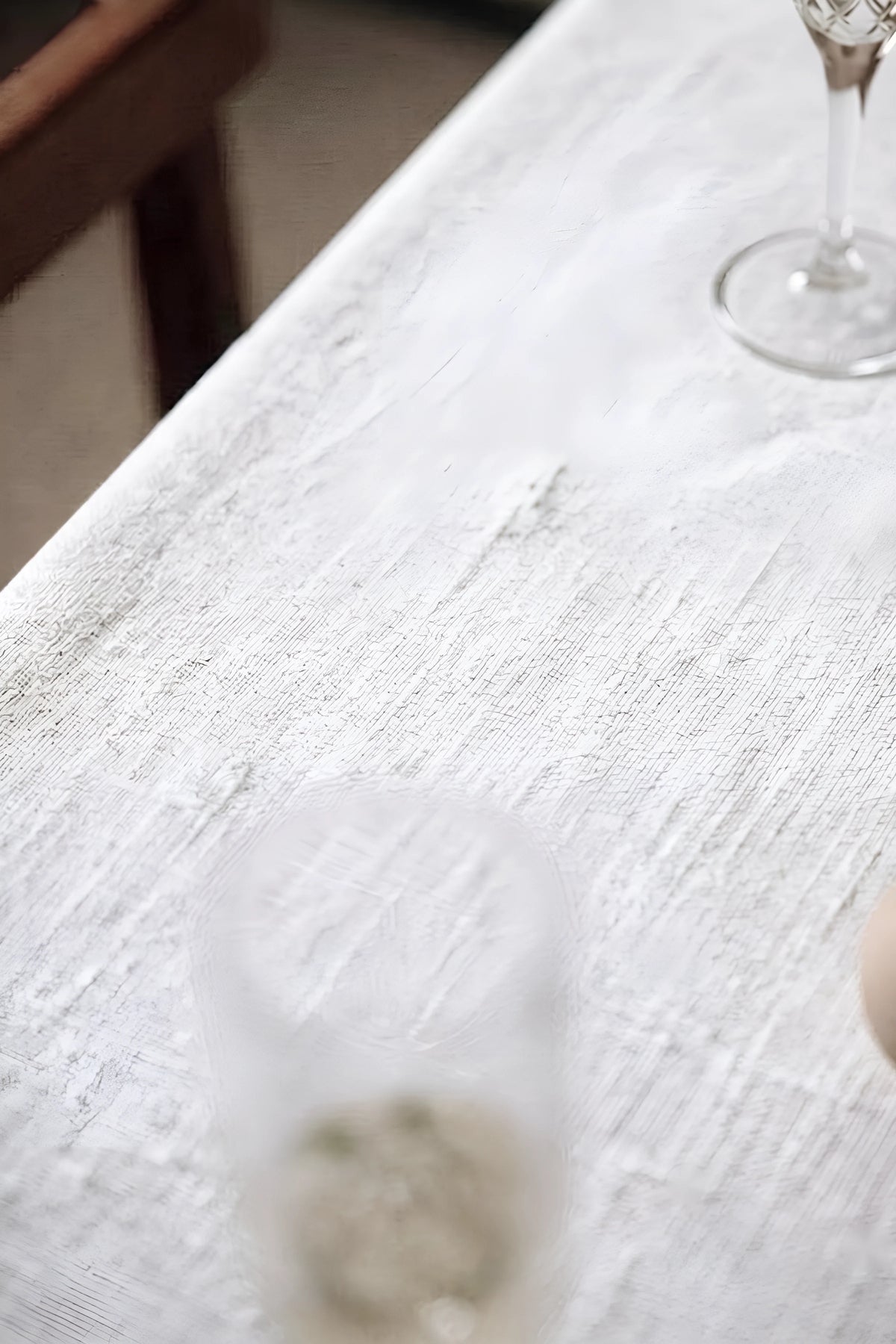 White plain linen cotton blend tablecloth fabric texture close-up with a wine glass. 9 sizes, handmade in Denizli, OEKO-TEX. VivaMaison.