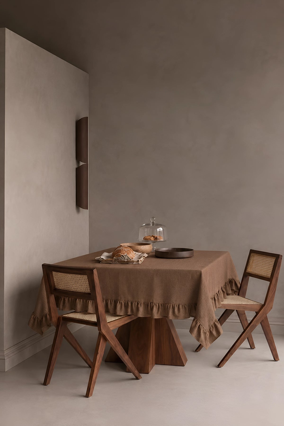 Brown ruffled linen cotton blend tablecloth on a dining table in a modern dining room with cane chairs. 9 sizes, handmade in Denizli, OEKO-TEX. VivaMaison.
