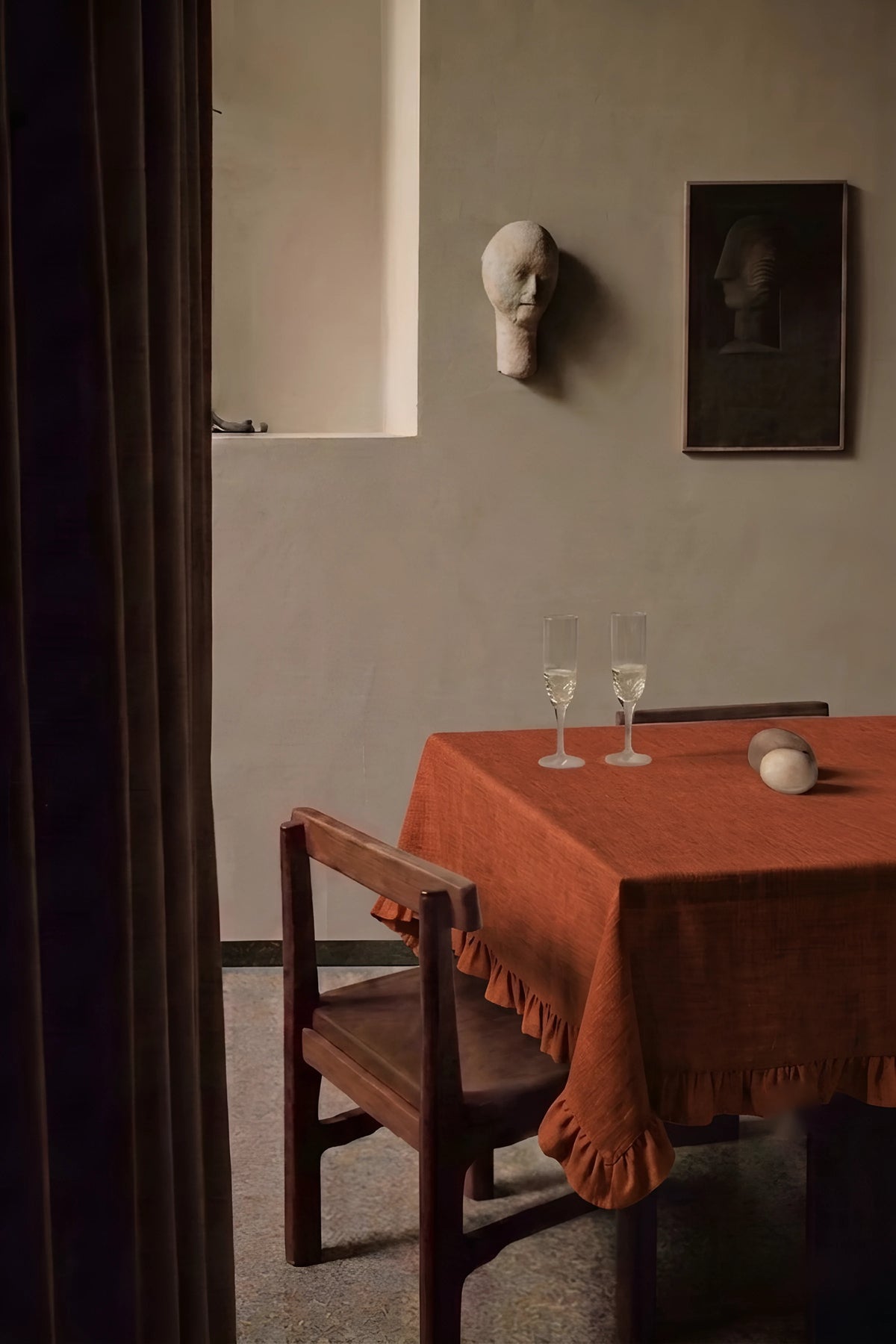 Cinnamon ruffled linen cotton blend tablecloth on a dining table with champagne flutes, seen through a doorway. 9 sizes, handmade in Denizli, OEKO-TEX. VivaMaison.