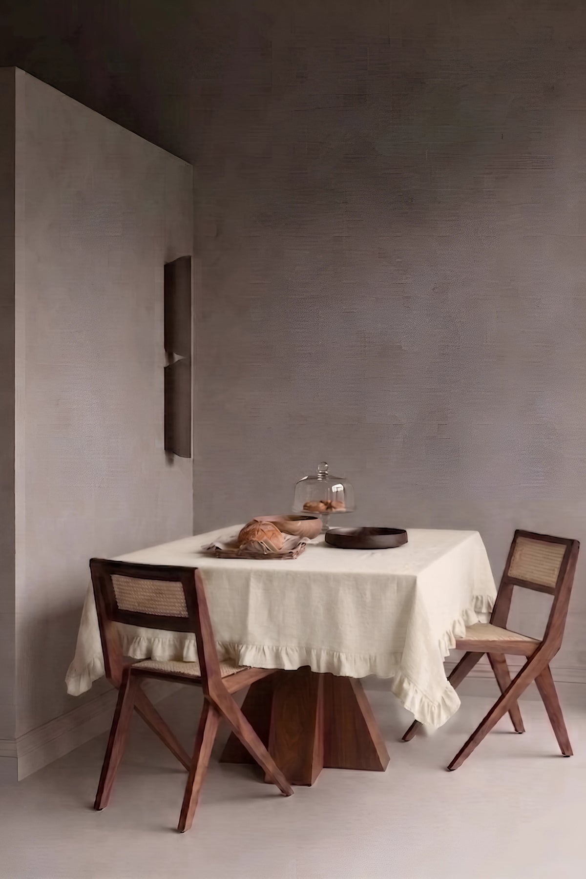 Natural ruffled linen cotton blend tablecloth on a dining table in a modern dining room with cane chairs. 9 sizes, handmade in Denizli, OEKO-TEX. VivaMaison.