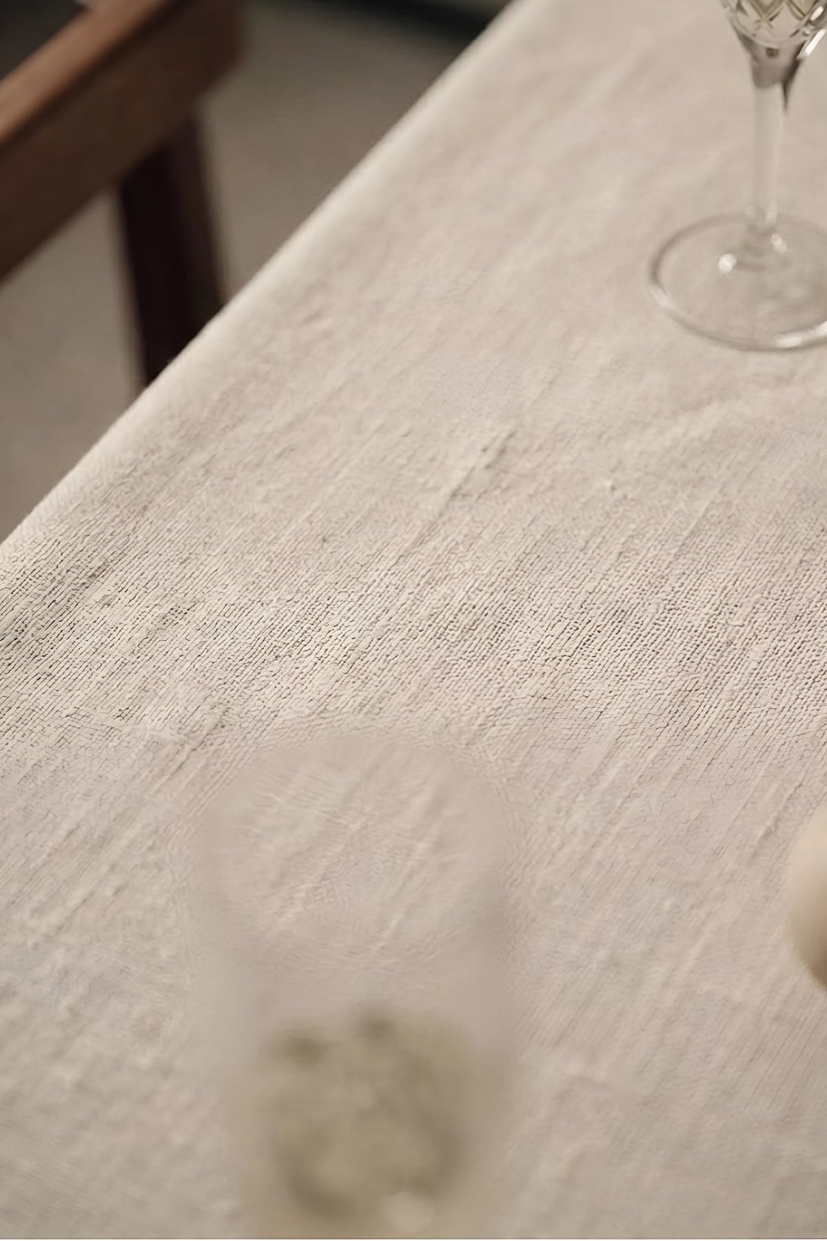 Natural ruffled linen cotton blend tablecloth fabric texture close-up with a wine glass. 9 sizes, handmade in Denizli, OEKO-TEX. VivaMaison.