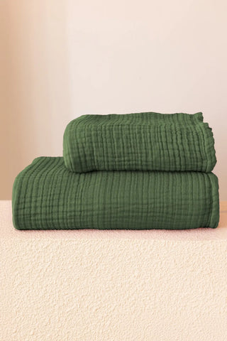 Forest green 4-layer muslin bath towel styled in a bathroom — Turkish cotton, OEKO-TEX certified Denizli