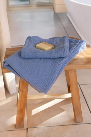 Indigo blue muslin Turkish towel in a cool-toned home scene, handwoven OEKO-TEX certified VivaMaison cotton
