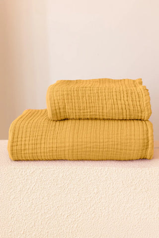 Mustard handwoven muslin towel in a styled bathroom setting, OEKO-TEX certified VivaMaison Turkish cotton