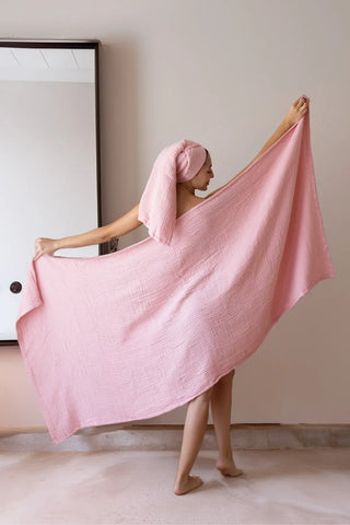 Pink handwoven muslin towel in a styled bathroom setting, OEKO-TEX certified VivaMaison Turkish cotton