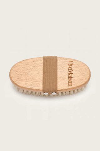 Natural bristle dry body brush with oval beech wood body and elastic hand strap on white background - VivaMaison