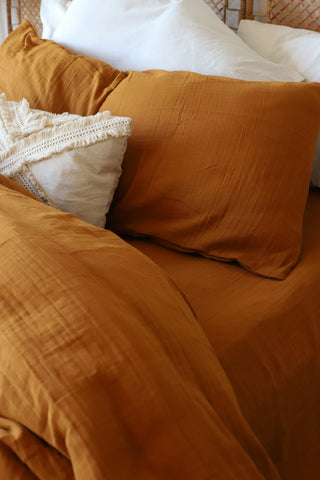 Caramel plain muslin duvet cover showing breathable weave by Vivamaison