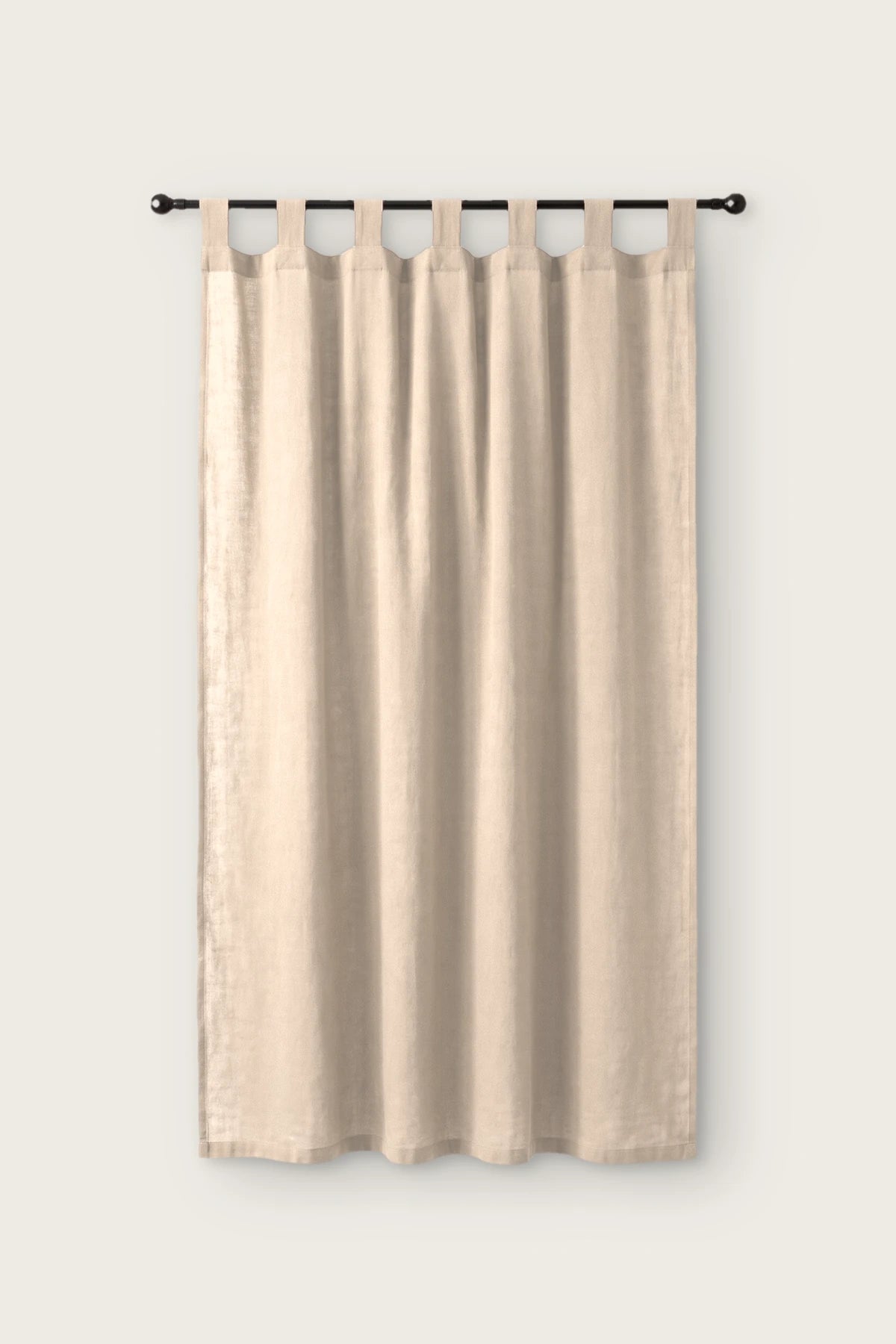 Stonewashed cotton curtain panel in beige, single tab top panel on a black rod, front view
