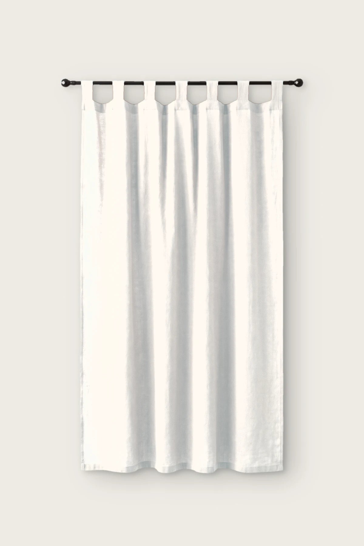 Stonewashed cotton curtain panel in white, single tab top panel on a black rod, front view