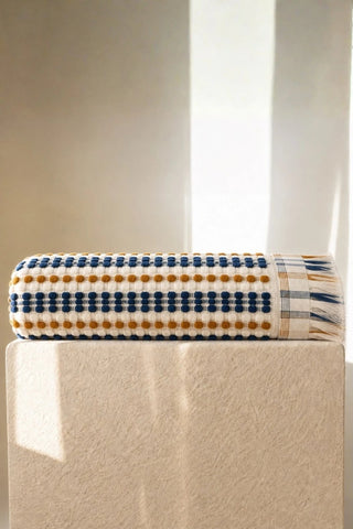 Blue Brown Turkish cotton mosaic towel folded on a plinth - VivaMaison