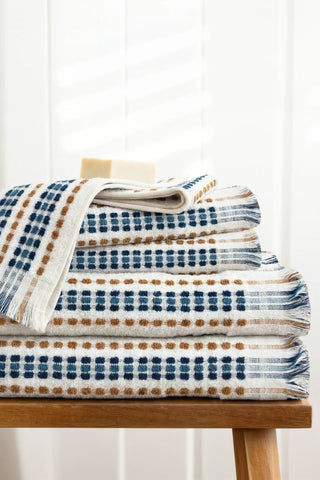 Blue Brown Turkish cotton mosaic towel stacked on a wooden bench - VivaMaison