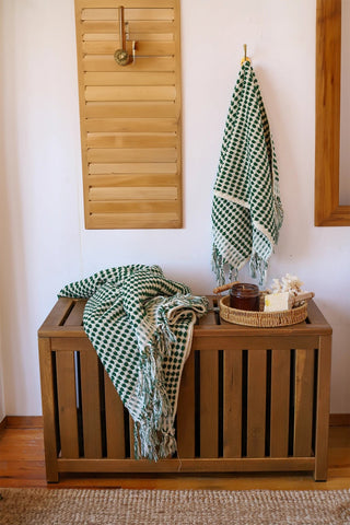 Green White Turkish cotton mosaic towel in a bathroom, hanging and draped over a wooden chest - VivaMaison