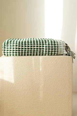 Green White Turkish cotton mosaic towel folded on a plinth - VivaMaison