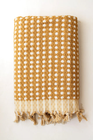 Mustard Turkish cotton mosaic towel folded front view with bobble texture and knotted fringe - VivaMaison