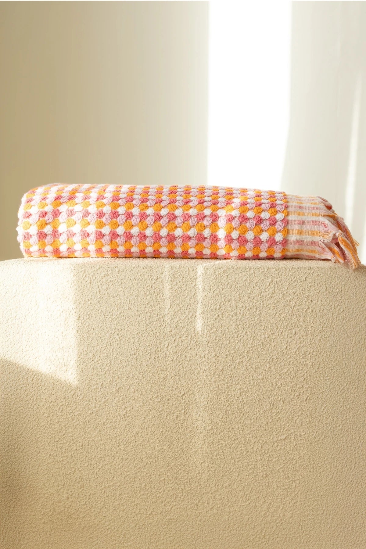 Orange Pink Turkish cotton mosaic towel folded on a plinth - VivaMaison