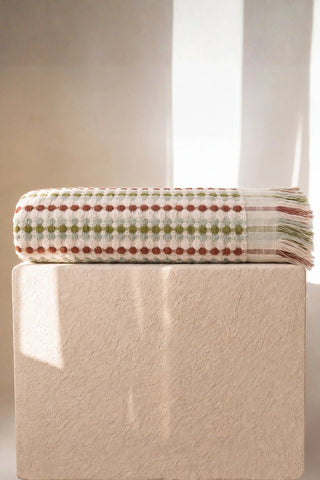 Sage Brown Turkish cotton mosaic towel folded on a plinth - VivaMaison