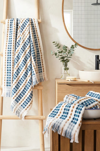 Blue Brown Turkish cotton pom pom towel hanging on a wooden ladder - VivaMaison
