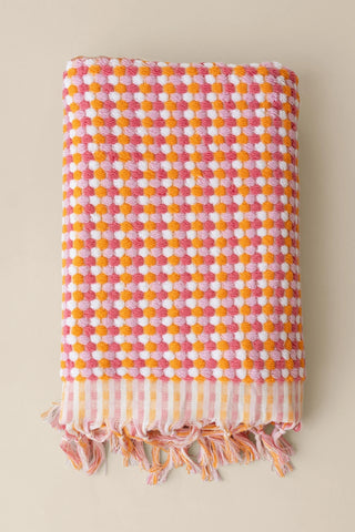 Orange Pink Turkish cotton pom pom towel folded front view with bobble texture and knotted fringe - VivaMaison